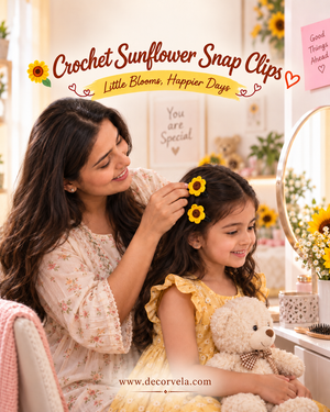A woman and a young girl in a sunflower-themed room, with the woman adjusting yellow sunflower snap hair clips on the girl's hair. The image features promotional text reading 'Crochet Sunflower Snap Clips' and 'Little Blooms, Happier Days' with the brand name 'DecorVela' at the bottom.