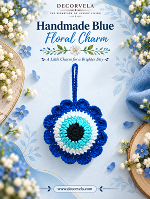 A handmade blue floral evil eye charm with a blue loop at the top, displayed on a light blue background with decorative flowers and text reading 'Decorvela Handmade Blue Floral Charm'.