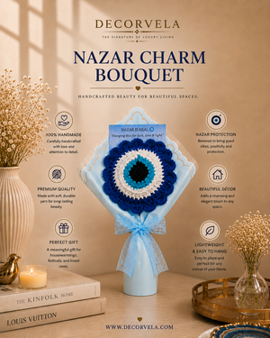 A crocheted Nazar charm bouquet displayed on a light blue ribbon-wrapped stand in a styled interior scene. The bouquet is centered against a warm beige wall with decorative dried flowers, books, a candle, and a tray.